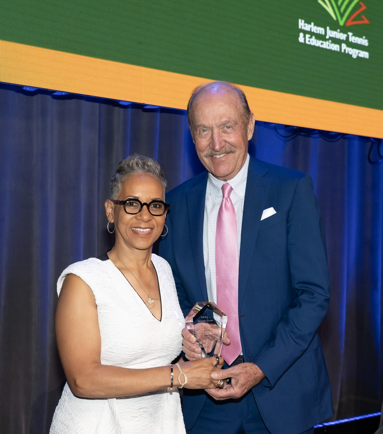 Ktrina Adams presenting Stan Smith with Award at HJTEP Gala-posing for camera.
